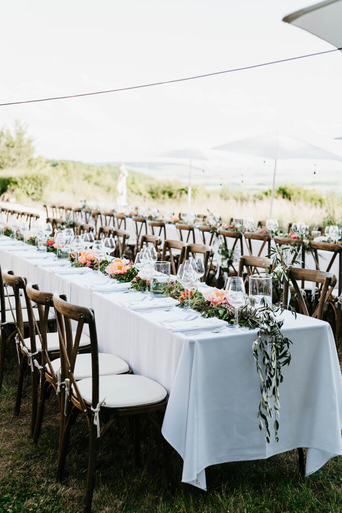 Long dining tables for outdoor wedding dinner in France